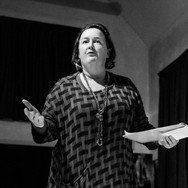 Someone reading a story aloud, on stage