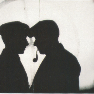 The silhouette of two people facing eachother