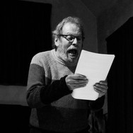 Someone reading a story aloud, on stage