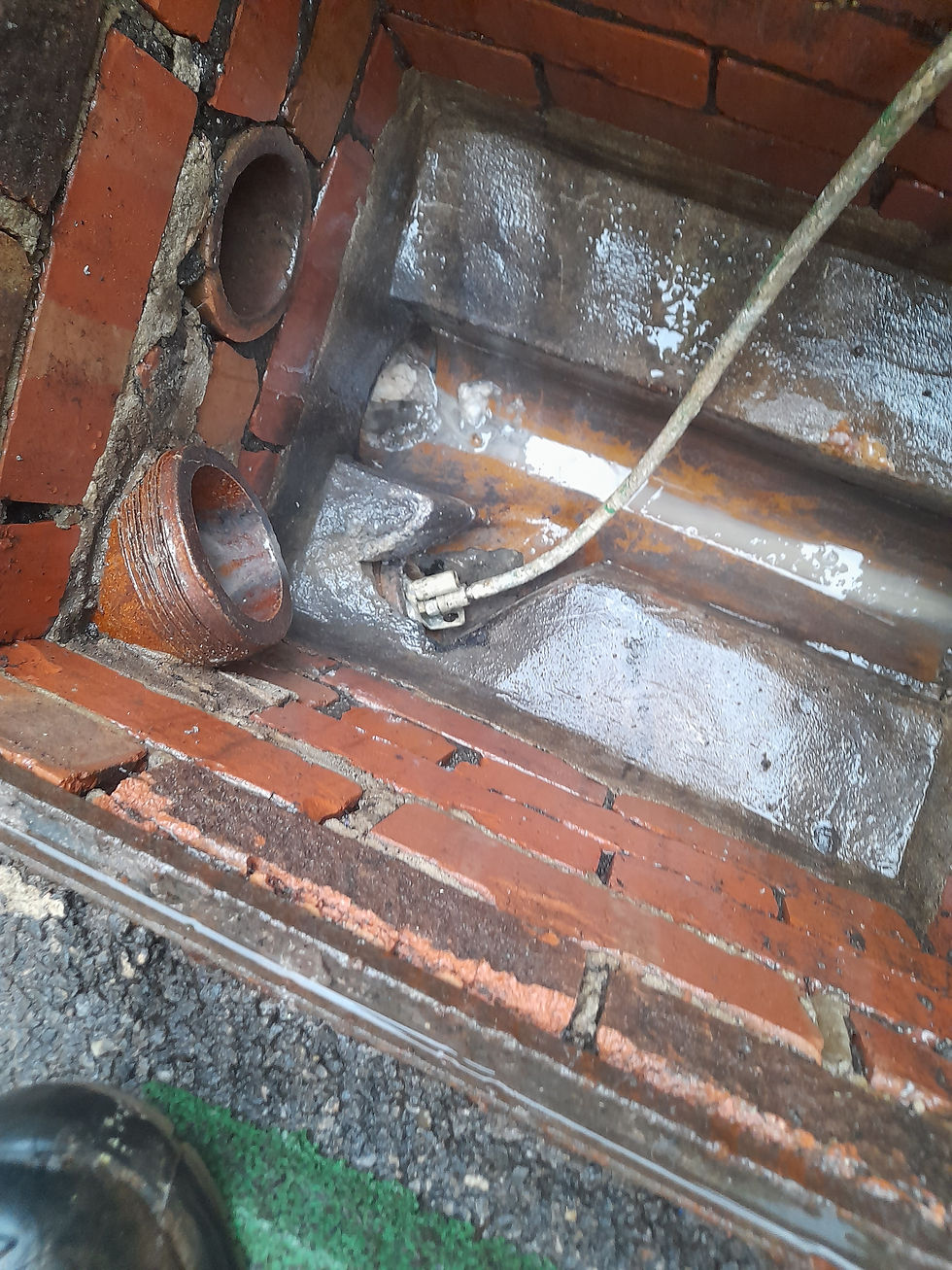 Open brick inspection chamber and drain access photographed during local lining work in Clevedon