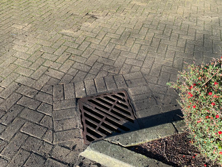 Surface-water gully grate in block paving photographed during the Avonmouth drainage job