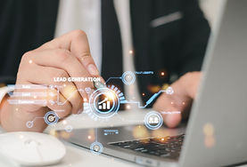 Business professional using a laptop with virtual graphics representing lead generation.