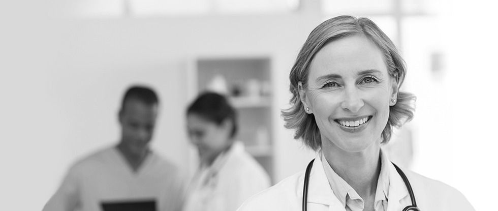 Female physician CEO leading a team meeting on healthcare strategy and innovation
