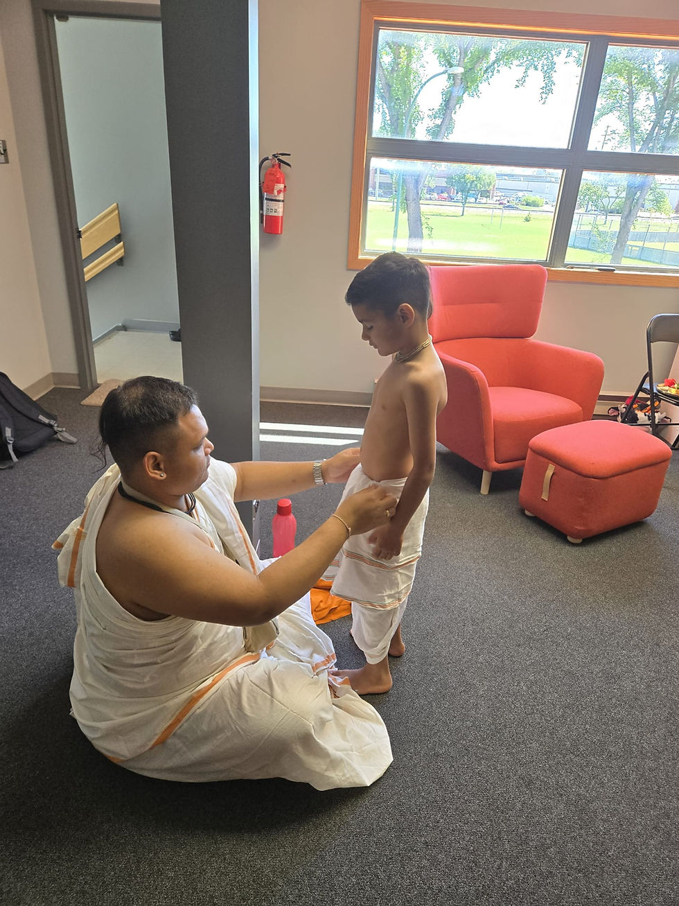 IN PREPARATION FOR JANMASTAMI, A PUJARI (PRIEST) HELPS HIS NEPHEW GET READY.
