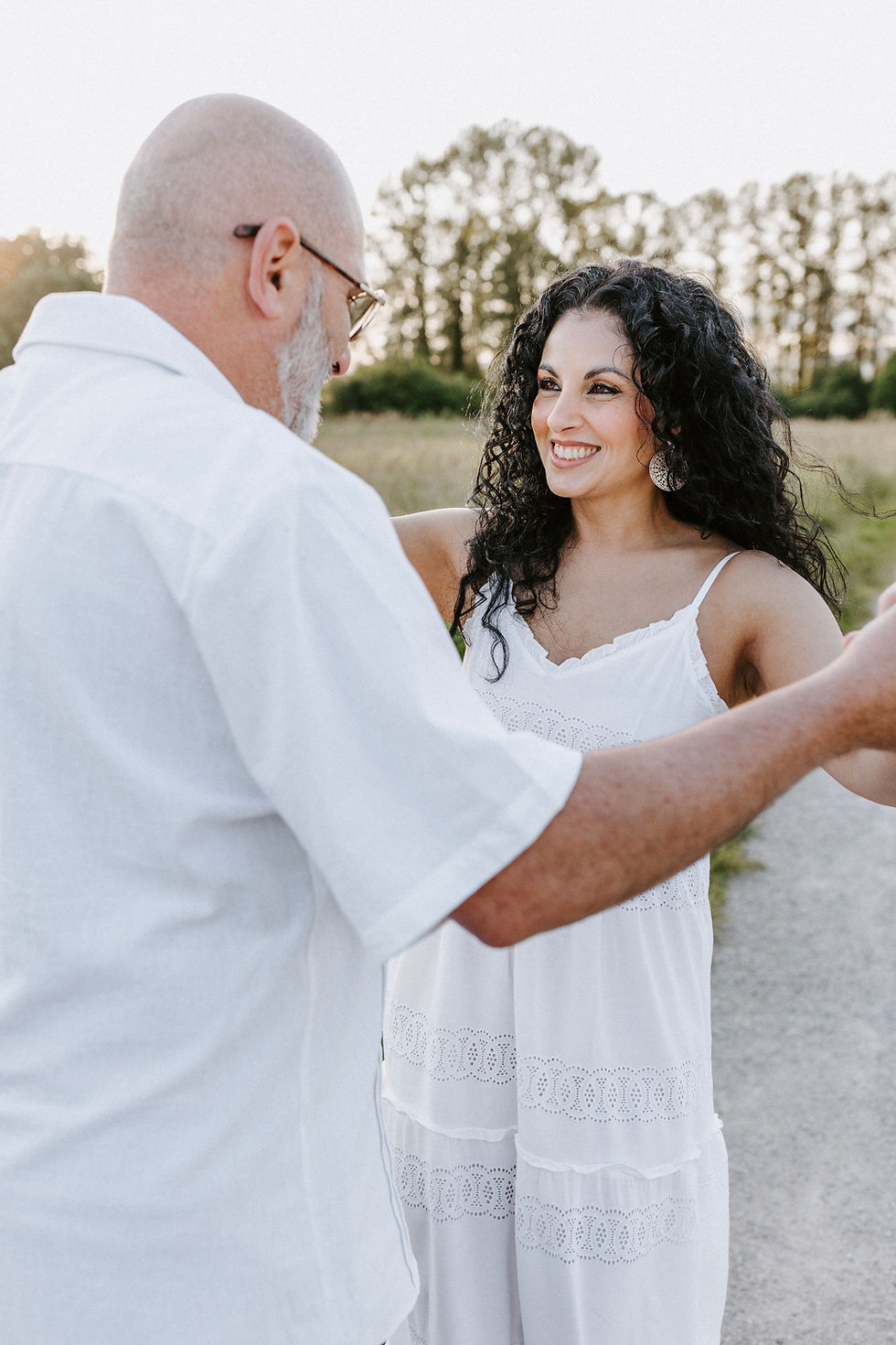 Rosangela Atte with her husband in a wheat field at golden hour, representing love, faith, and healing