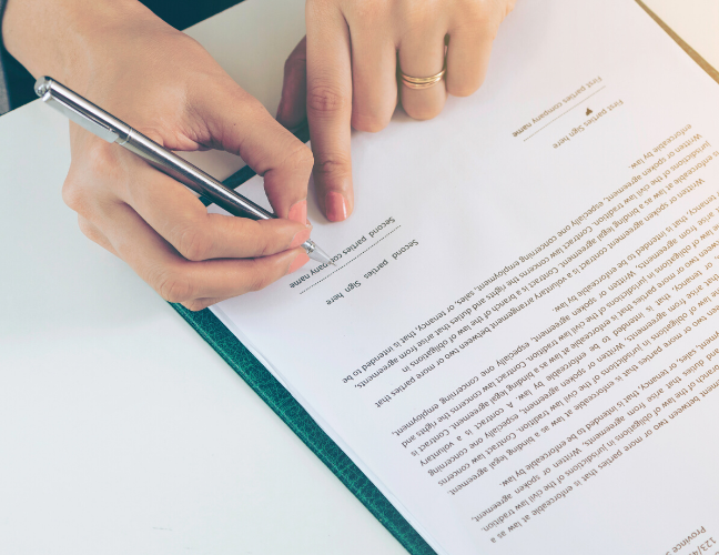 Woman signing a surrogacy contract