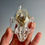 Thumbnail: Glass Raccoon Skull filled with Snakeskin and Bones
