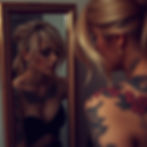 blonde woman with tattoos in mirror.jpg
