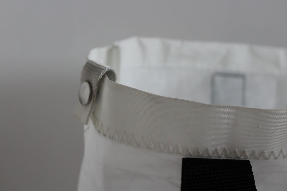 Thumbnail: close up view to a pop down button with is original to the sail and can still be used.