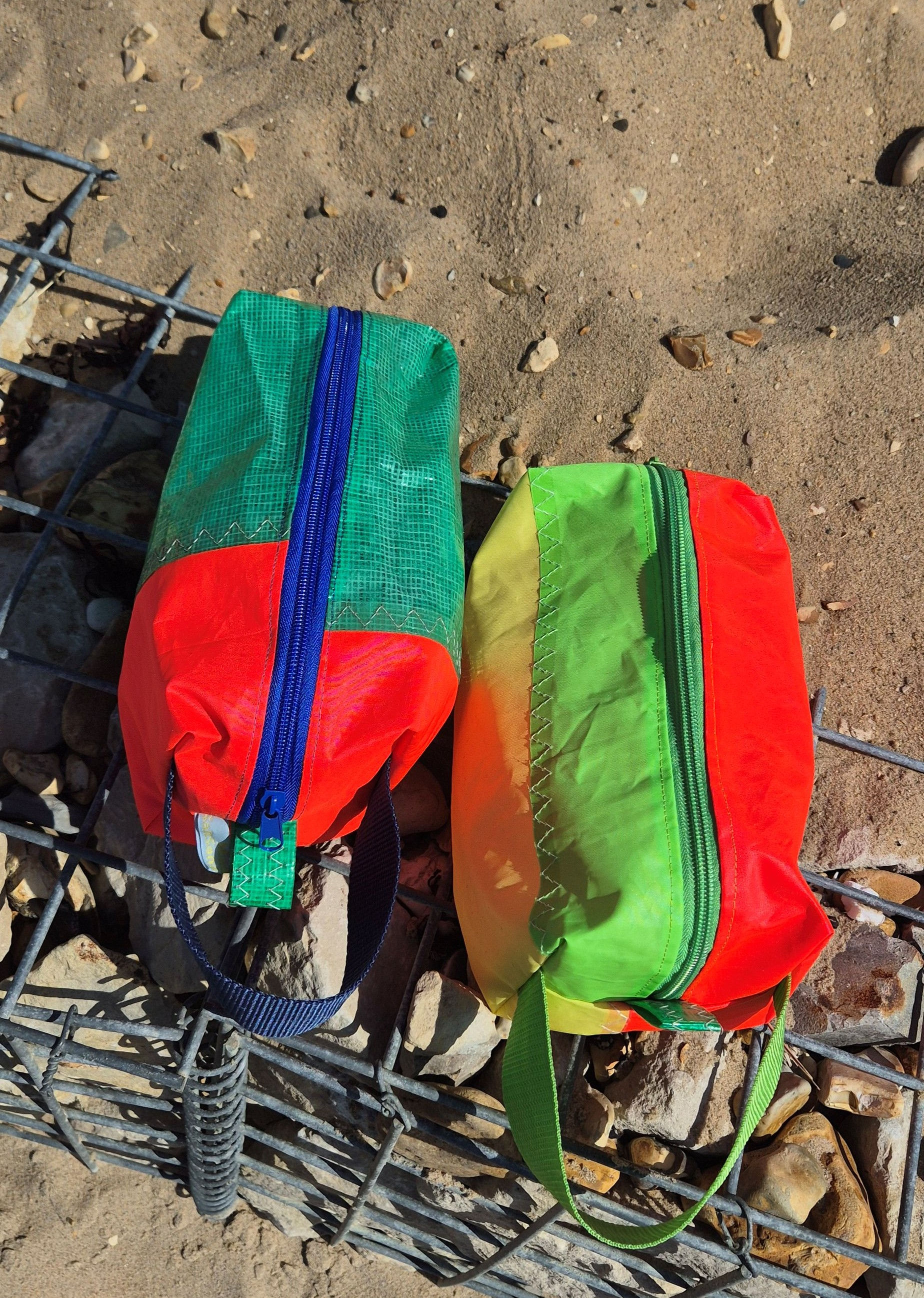 Green and pink washbag with blue zip and handle and pink green and yellow washbag with green handle and green zip