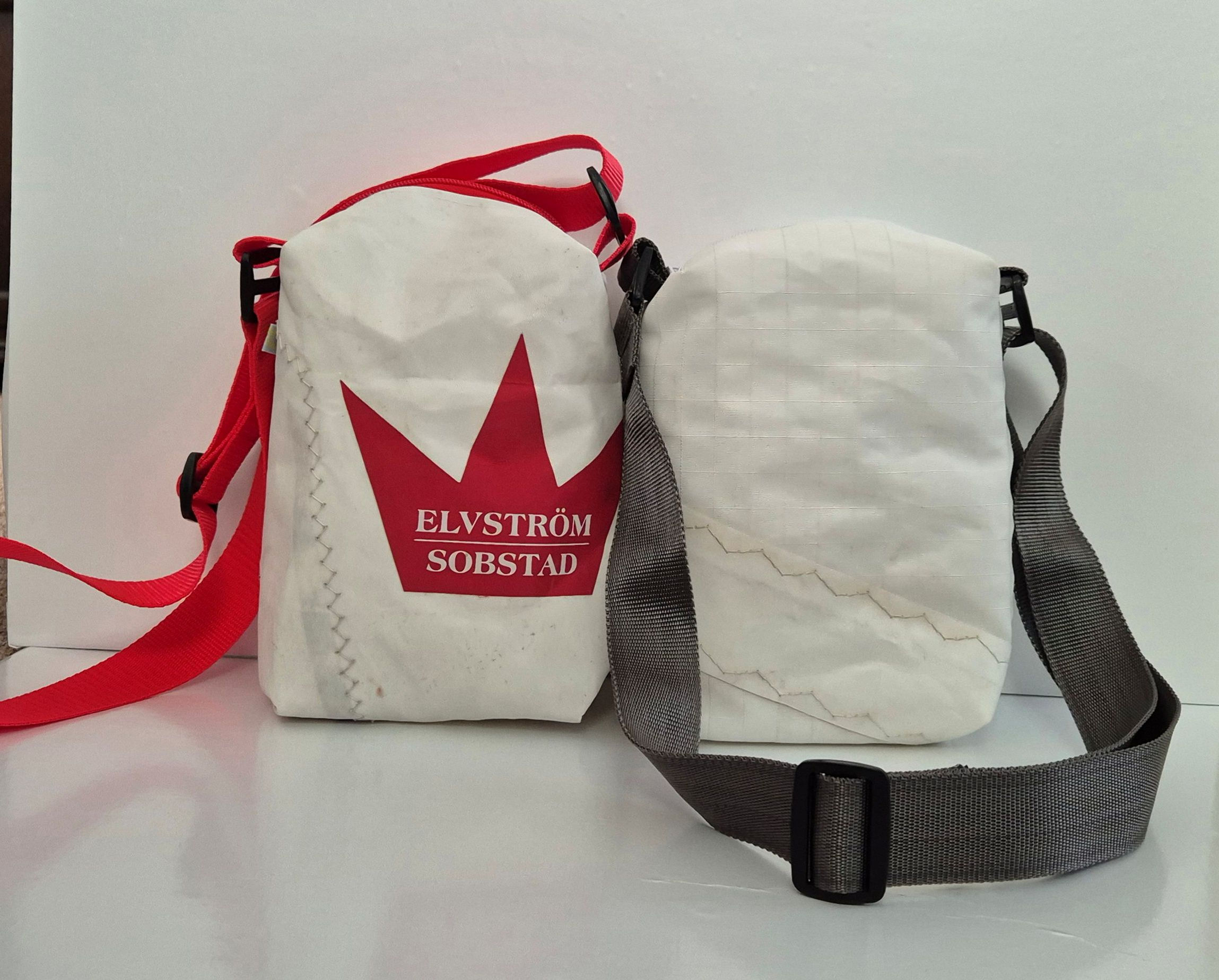 two white Sail Bags, one with red one with silver grey crossbody straps on white background