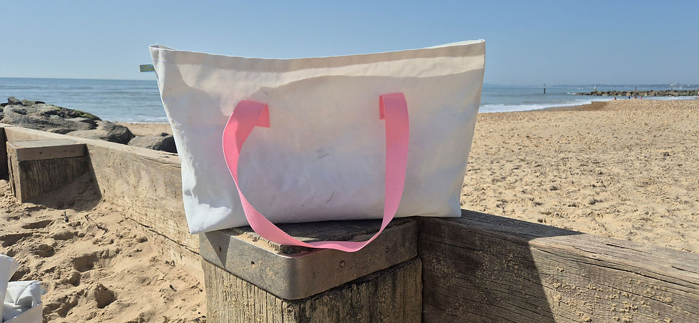 White Sail bag with pink Handles on the beach