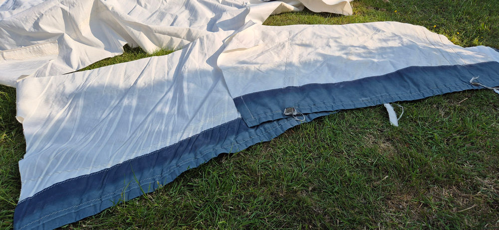 White and Blue Sail Cut off pieces on Grass