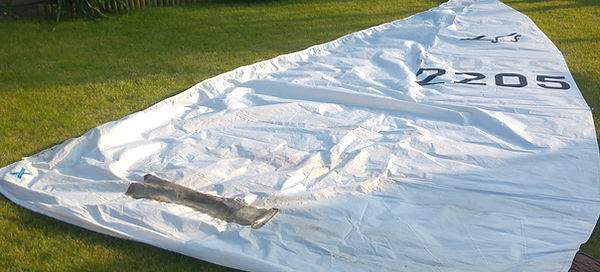 large white sail on a green