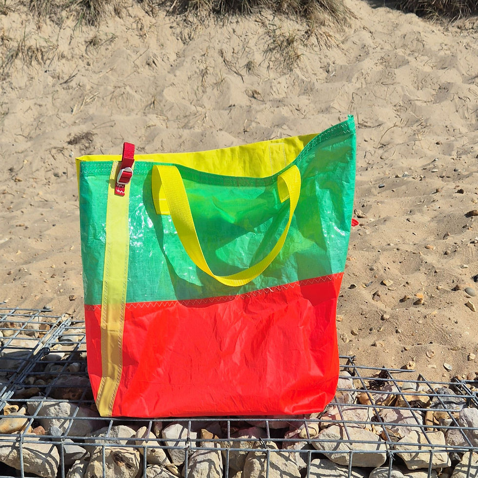 Large Shoulder Bag made of Pink, green and yellow sailcloth. Yellow handles are hanging down, red hoop on left