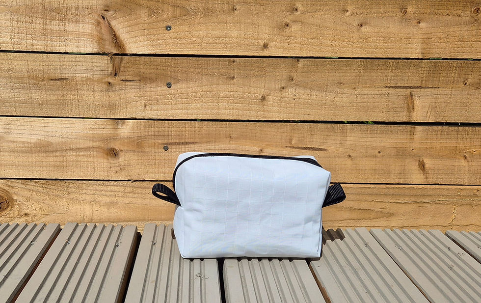 Thumbnail: black zipped Sail cloth washbag with black hooks on side. Outside setting