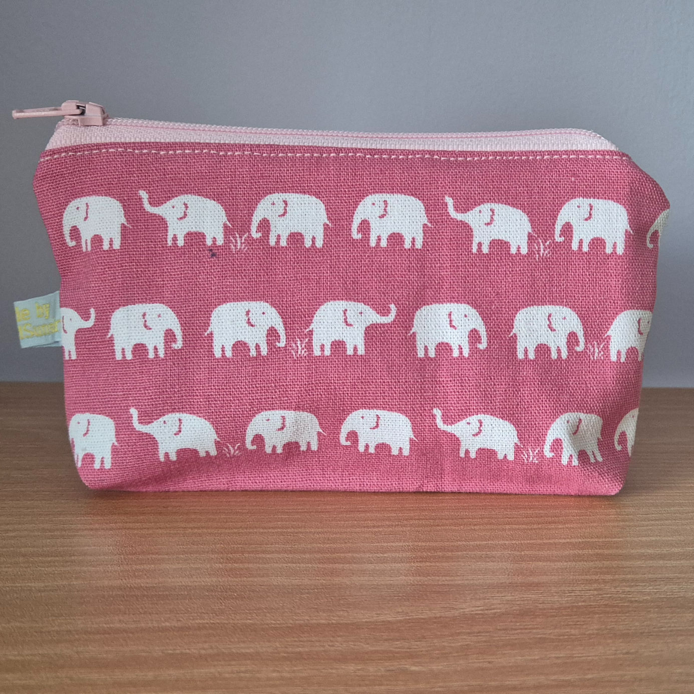 small pink pouch with white elephant print and light pink zip