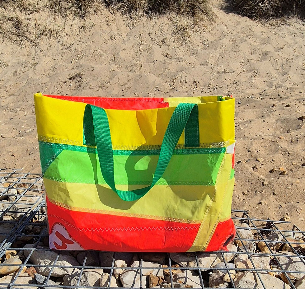 Colour Burst Sailcloth Tote Bag on a sandy beach.