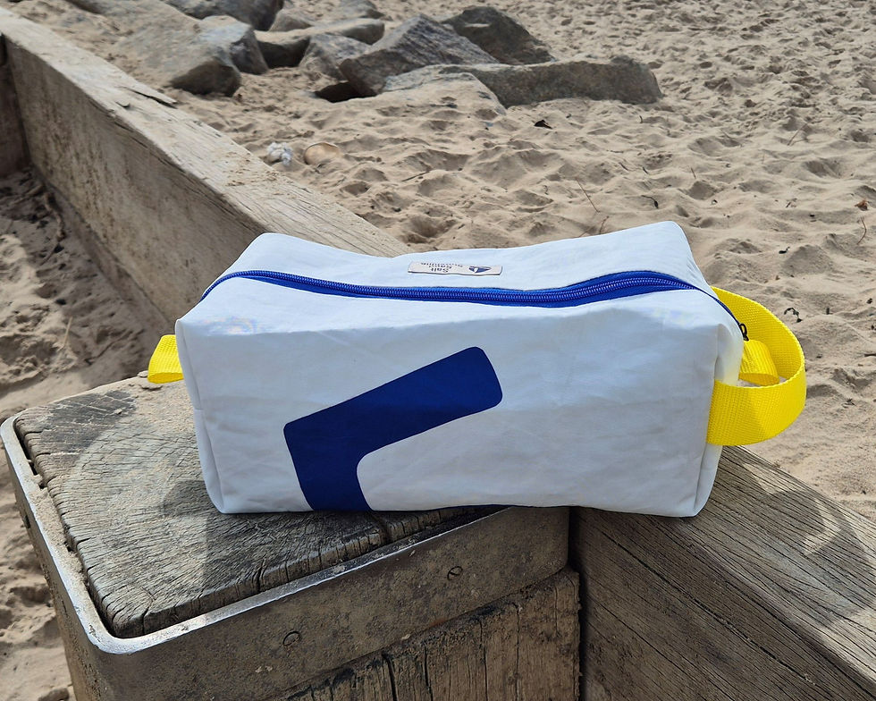 White Sailcloth bag. Yellow handle on one side, nautical no. 5 and blue zip on top