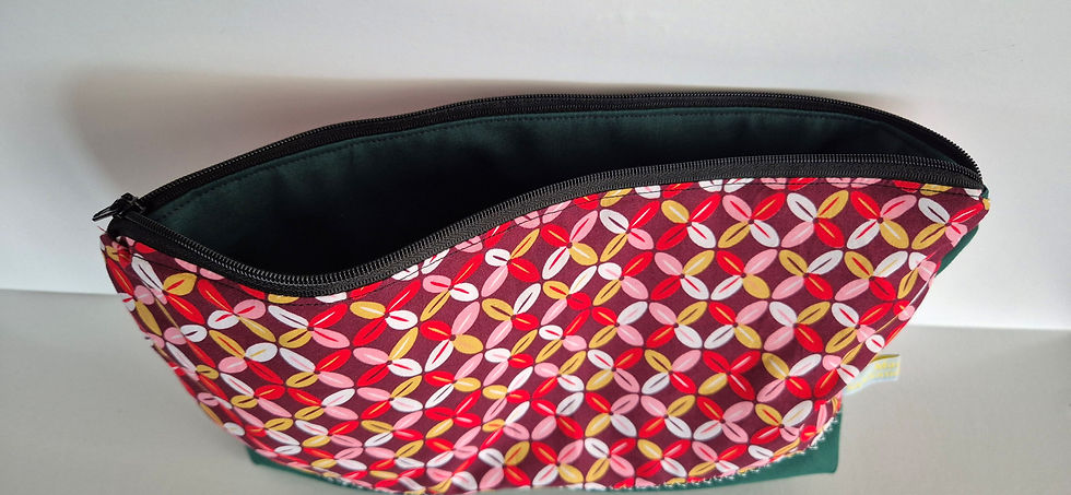 Thumbnail: Patterned handmade cosmetic pouch with open zip and dark green lining
