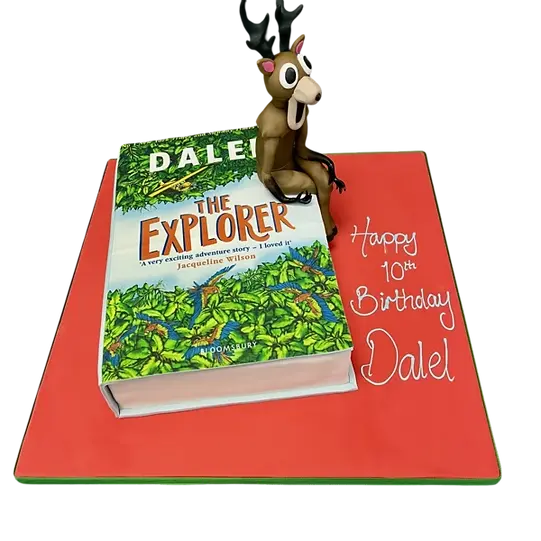 Bespoke cake in Solihull, West Midlands shaped like an explorer book with a Roblox character on top for celebration.