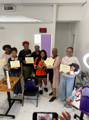 Group of students holding certificates after Reeta’s Organics Beginner Braiding Class in Orlando.