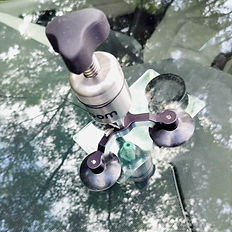 Windshield chip repair tool with resin injector during mobile repair service in Gainesville Florida.
