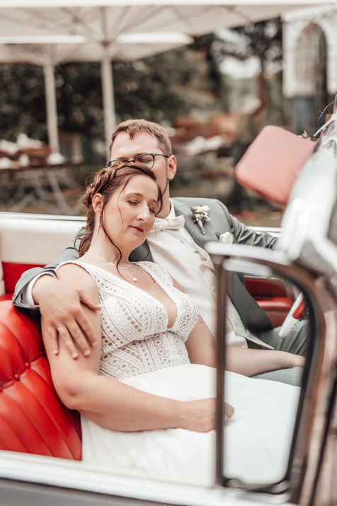 Brautpaar in rotem Auto