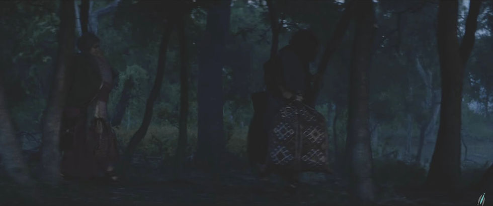Figures flee through a dark forest at night