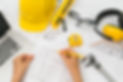 hand-construction-plans-with-yellow-helmet-drawing-tool.jpg