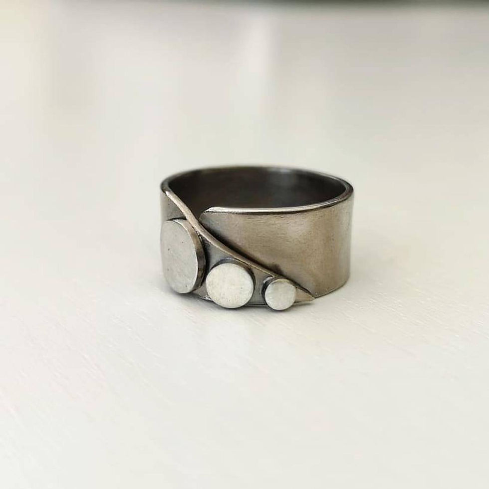 Oxidised silver wrap ring with three silver buttons