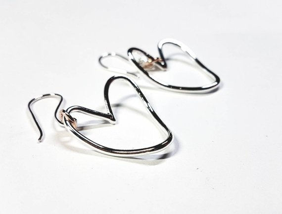 Gorgeous silver curved heart earrings.