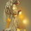 Thumbnail: An angel with long wings stands in a prayer pose, gently looking at her palms