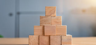 wooden blocks stacked in pyramid shape on table