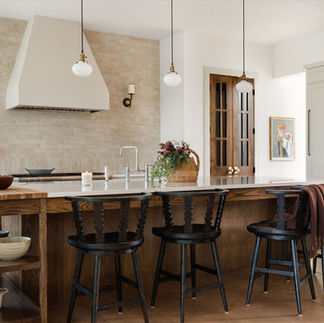 A Younger Homes Semi-Custom kitchen with a butcher block extension on the island.