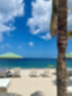 chairs and an umbrella on a beach