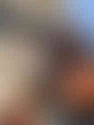 Mr. Redlegs statue with two people posing with it