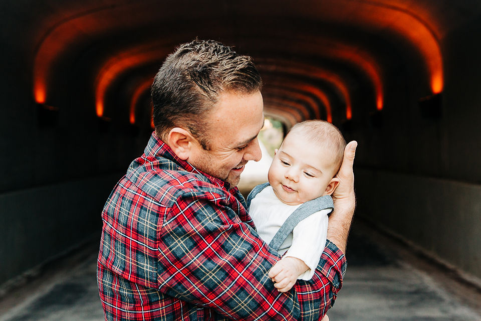 father holding son while they giggle