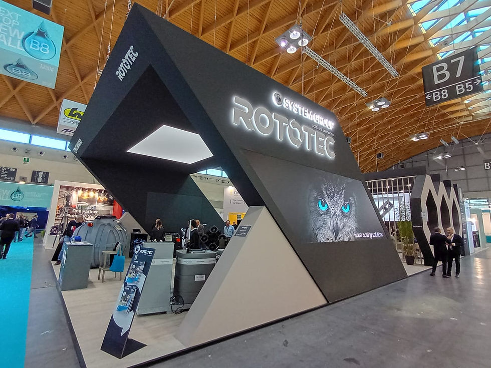 Sleek black-and-gray structure with a large digital display, interactive stations, and product demos that invite curiosity and conversation. @MBA Photography