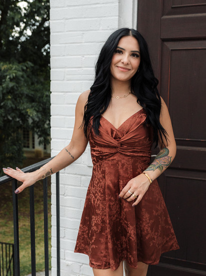 woman wearing reddish brown floral fit and flare mini dress