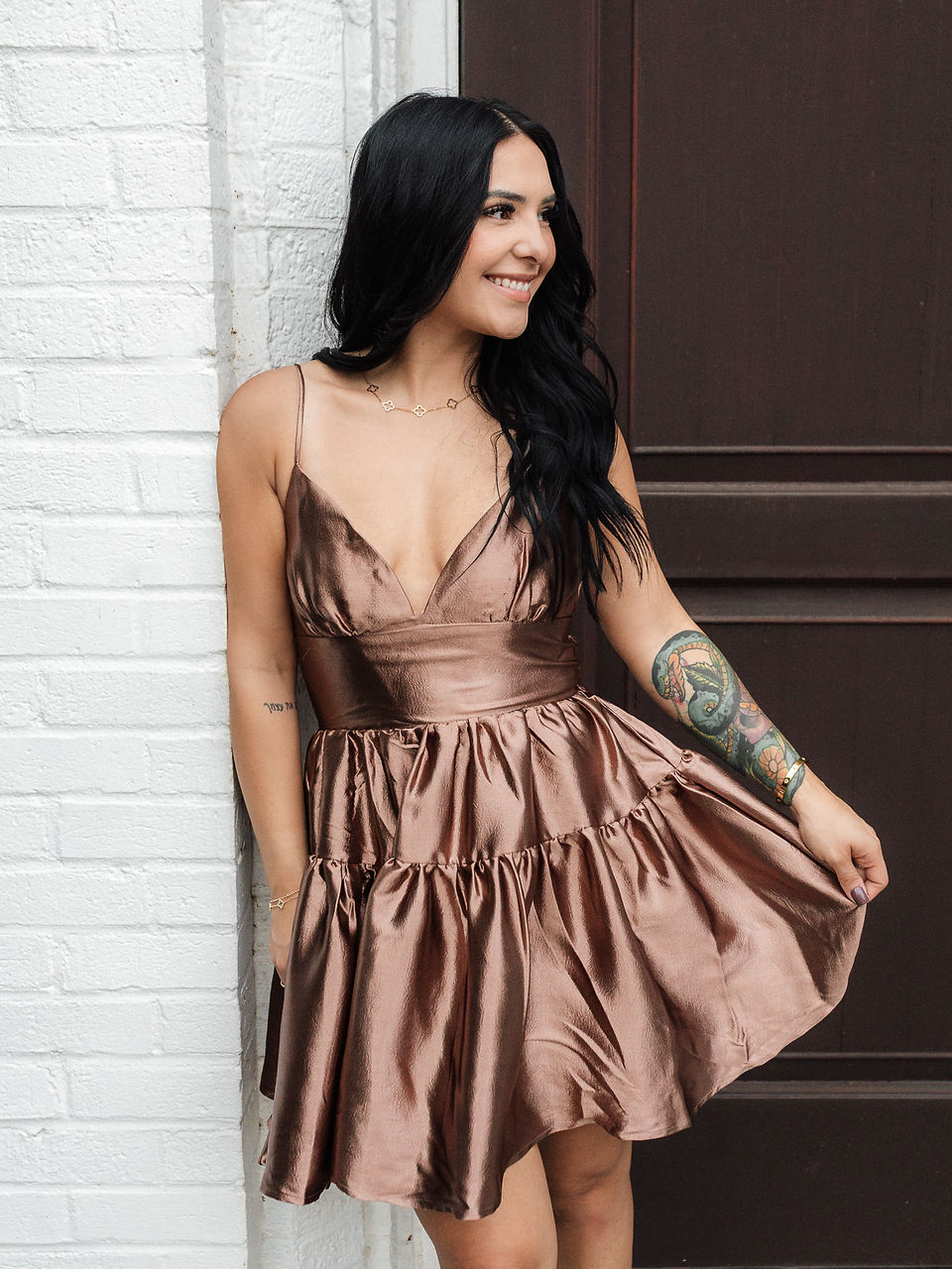 woman wearing tiered brown satin mini dress
