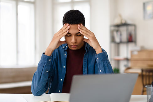 stressed-teen-guy-studying-with-laptop-suffers-hea-2024-04-02-17-34-16-utc.jpg