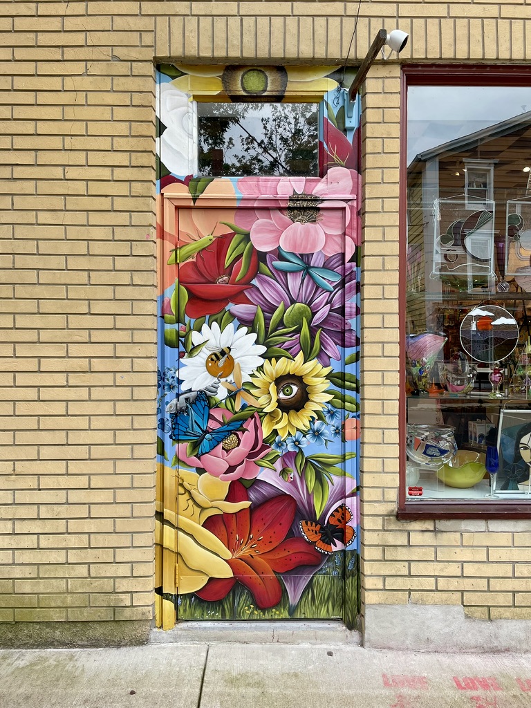 Original local-business photograph featuring a colorful floral mural and storefront