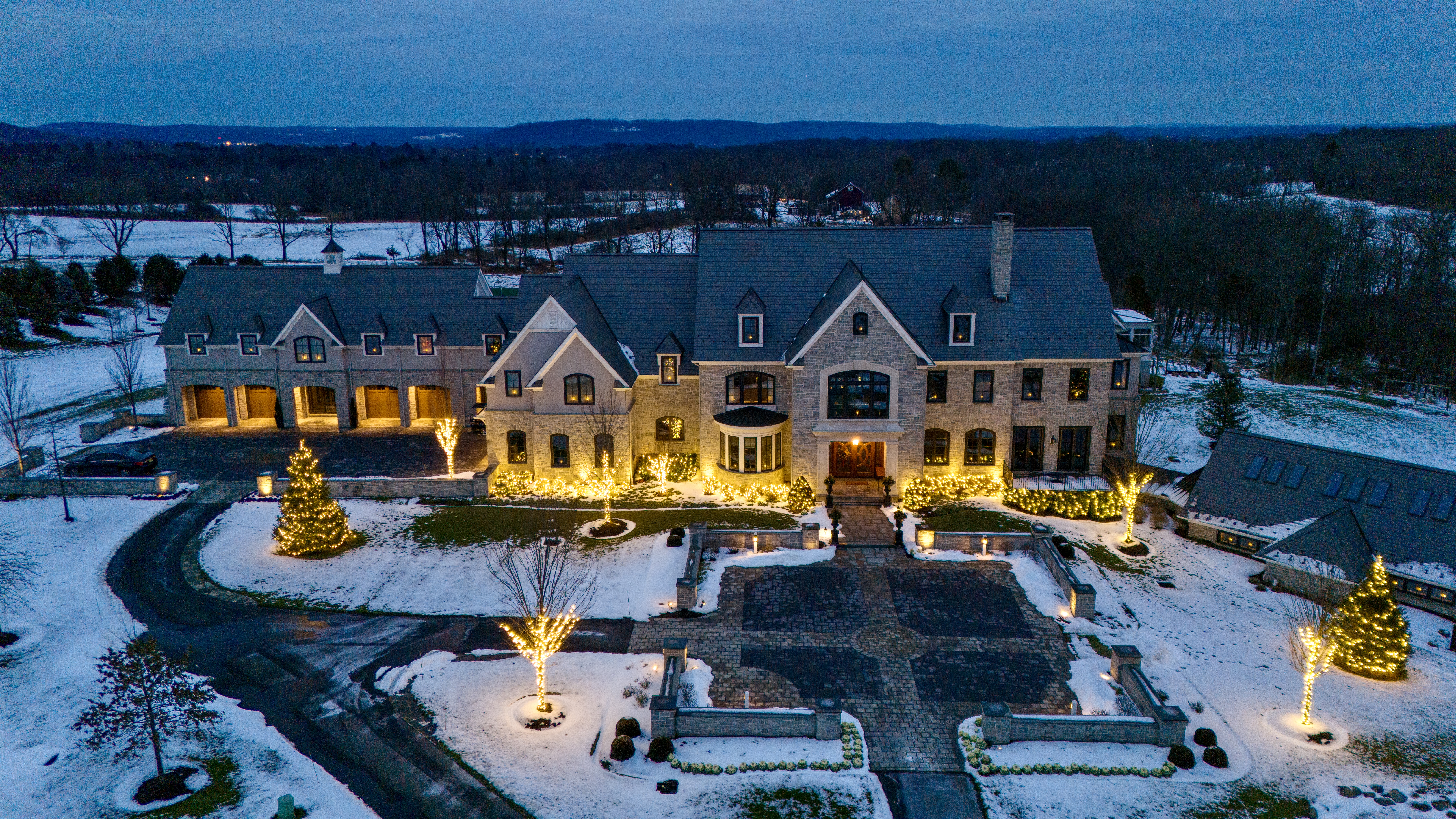 Original ArdeaDrones aerial photograph of a Doylestown property illuminated at winter blue hour