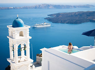 Cruise Trip Planner | GeoLuxe Travel | woman in pool overlooking Greek isle