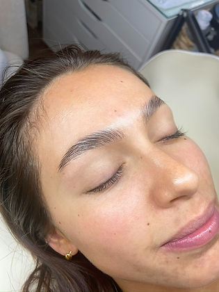 Client with softly styled laminated brows