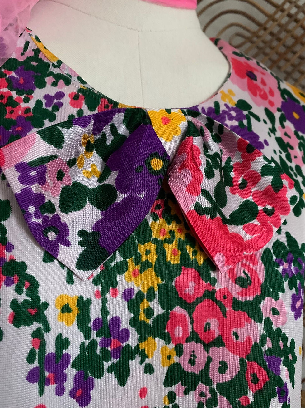 Thumbnail: Vibrant Floral Dicel 70s Shift Dress Close Up Bow Detail View