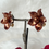 Thumbnail: Metallic Copper Brown Acrylic Flower Clip On Earrings Side View