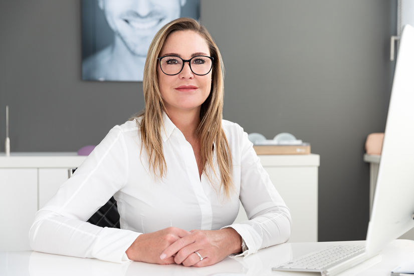 Frau am Schreibtisch mit Brille klar hell und clean Mitarbeiterfotografie Unternehmensfotos Berlin
