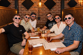 Guests posing together for a group photo at an indoor social event.